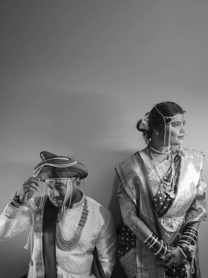 A stylish black and white portrait of the couple, showcasing their traditional Maharashtrian wedding attire with an artistic and timeless feel.