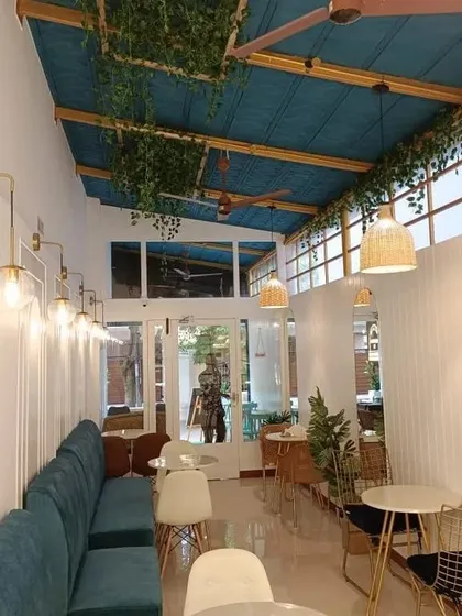 A key part of biophilic hospitality design is integrating natural light and greenery. We designed this cafe to feel bright and airy, using large windows and hanging plants to create a refreshing environment that encourages guests to stay longer.
