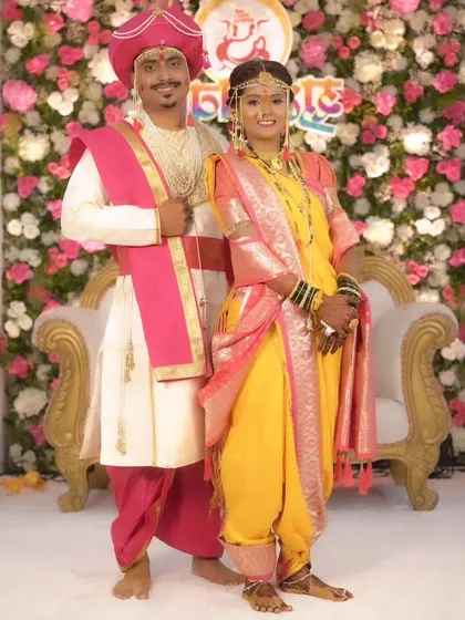 A beautiful Maharashtrian couple on their wedding day, dressed in traditional yellow and pink attire. I ensure both bride and groom look coordinated and picture-perfect.