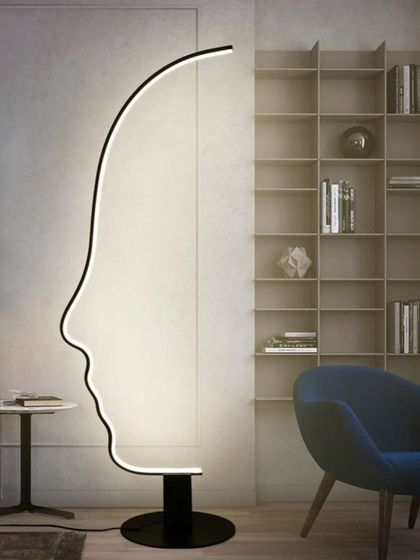 This floor lamp is a masterclass in graphic design, forming the silhouette of a human face with a single, continuous line of light. When lit, it provides a striking and artistic ambient glow, perfect for a modern living space or creative studio.