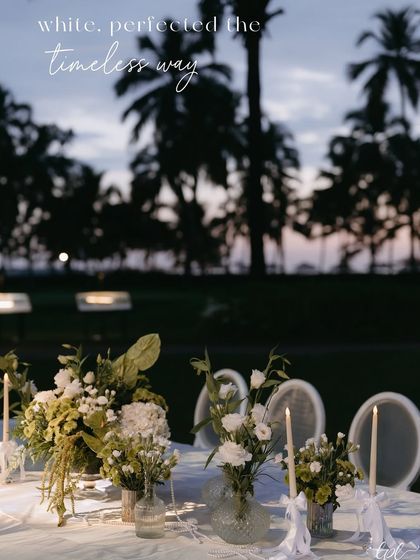 A beautiful tablescape set against the Goan sunset, with the text overlay "white, perfected the timeless way".