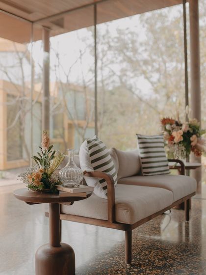 Our lounge area, with its floor-to-ceiling glass walls, feels like a sophisticated treehouse, offering panoramic views of the property.