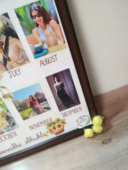 A detail shot of the lower corner of the calendar frame, showing the personalized name and decorations.