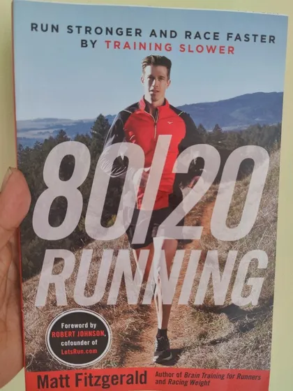 This book, '80/20 Running', is a cornerstone of my coaching philosophy. I believe that most of your weekly mileage should be at a low to moderate intensity, which builds a powerful aerobic engine and reduces the risk of burnout and injury.