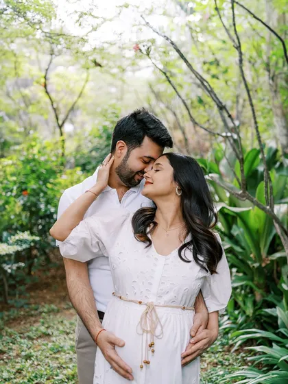 An intimate embrace amidst lush greenery. This close-up shot in the park focuses on their loving connection, with nature providing a beautiful, vibrant backdrop.
