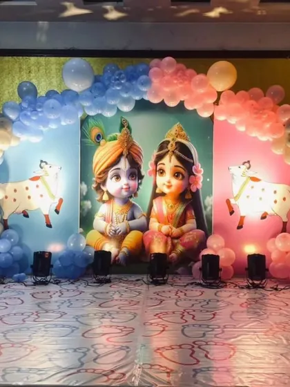 A different take on the Radha Krishna theme, this time for a naming ceremony or welcome party, using pink and blue to frame the beautiful central image.
