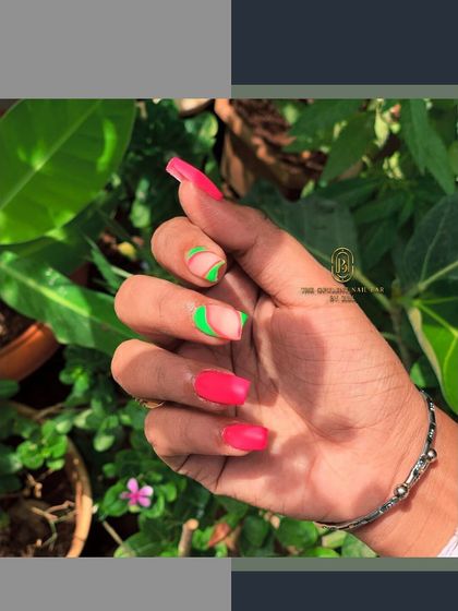 Make a statement with these vibrant neon nails. The combination of hot pink and electric green in an abstract design is guaranteed to turn heads.