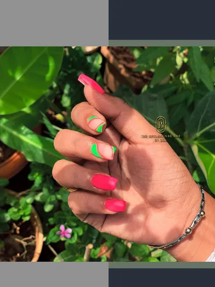 Make a statement with these vibrant neon nails. The combination of hot pink and electric green in an abstract design is guaranteed to turn heads.