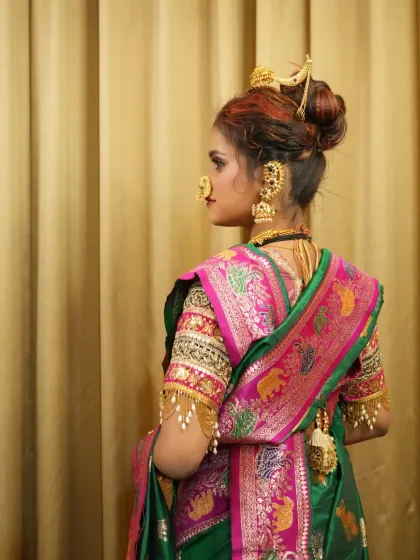 A back view showcasing the intricate design of the Paithani saree and the beautiful bridal bun.