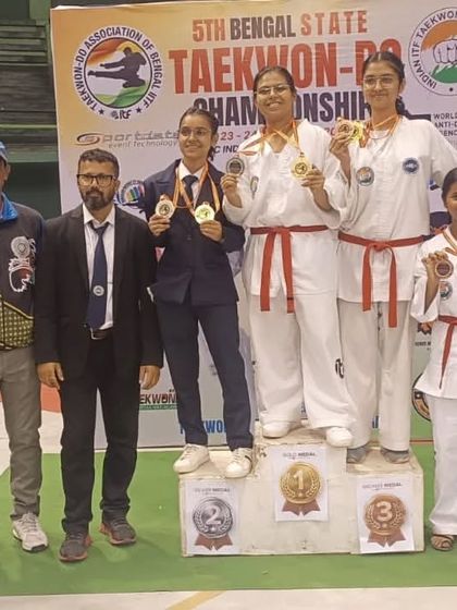 Senior female athletes with their medals, serving as role models for our younger students.