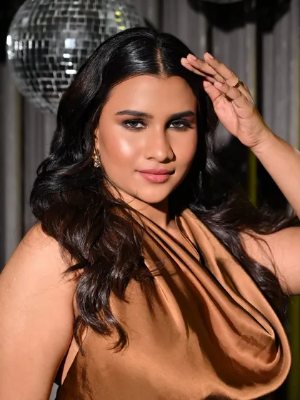 This confident pose shows off the complete look, from the voluminous hair to the perfectly defined eyes.