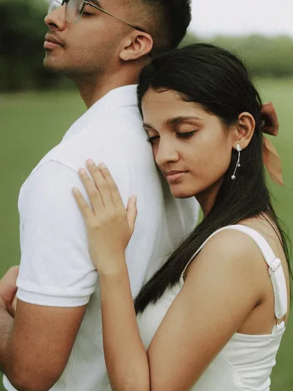 A moment of peaceful connection. Fiona rests her head on Austin's back, a simple, beautiful gesture of trust and comfort captured during their outdoor engagement photoshoot.