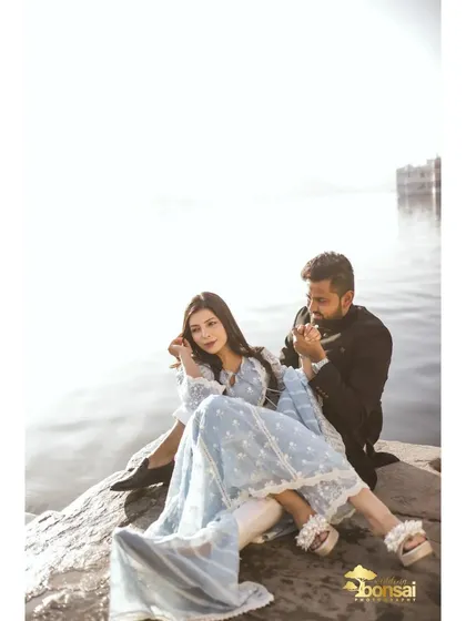 A quiet, intimate moment by the lake. This photo captures the peaceful and deep connection between the couple during their destination pre-wedding shoot.