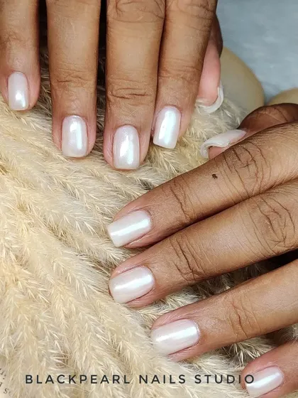Another view of the milky white chrome nails over a BIAB base, showcasing the smooth, durable, and elegant finish. This is ideal for clients who love a clean and sophisticated look.