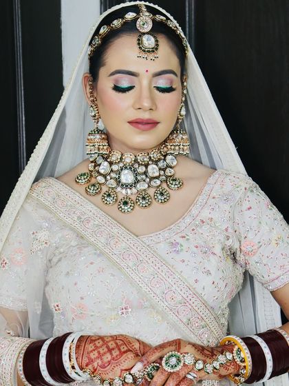 A serene portrait with eyes closed, focusing on the flawless makeup.