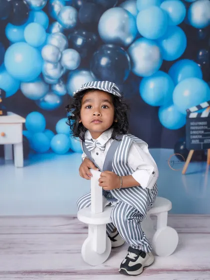 This two-year-old is looking sharp in his striped suit and bow tie, ready for his vintage-themed birthday photoshoot.