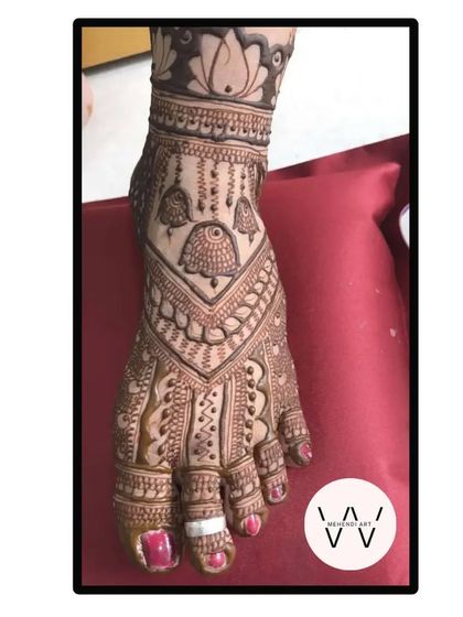 A close-up of a single foot with a detailed design featuring jhumka motifs.