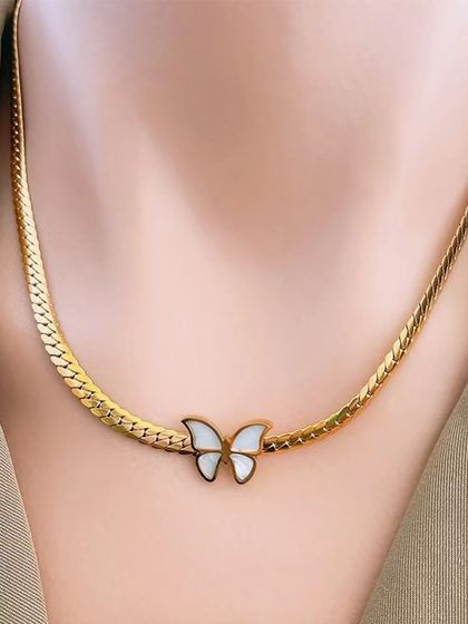 A delicate butterfly necklace with a mother-of-pearl inlay on a flat snake chain. This piece is elegant and perfect for spring and summer.