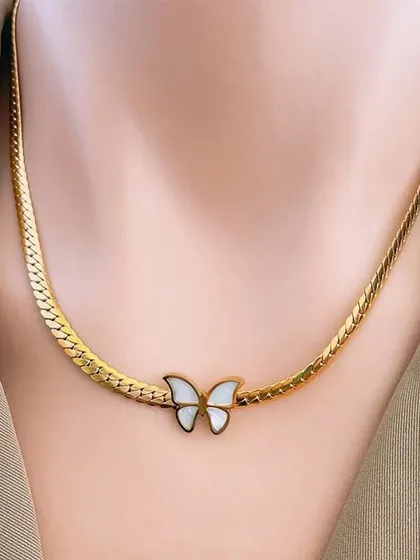 A delicate butterfly necklace with a mother-of-pearl inlay on a flat snake chain. This piece is elegant and perfect for spring and summer.