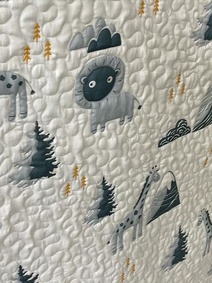 A detail shot of the woodland animal quilt, showing the stippling quilting.