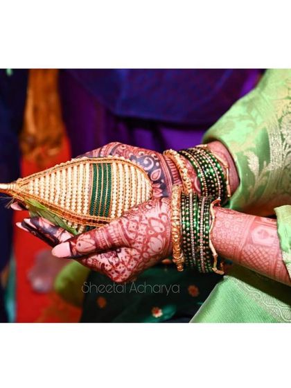 Mehendi is the first love of every bride. A close-up of a bride's hands during a traditional ceremony, her mehendi adding to the sanctity of the moment.