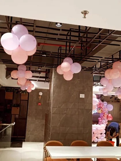 Another view of the ceiling decor with pastel balloon bunches. This shows how we can transform a simple space into a festive one with just a few elements.