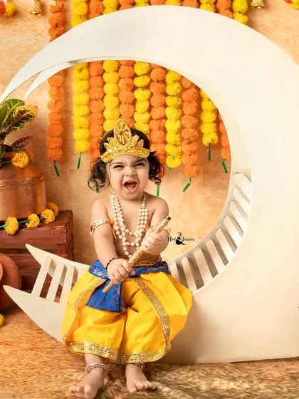 The pure, mischievous joy of a little Kanha. My Janmashtami mini sessions are a vibrant celebration, filled with laughter, traditional props, and lots of playful moments like this one.