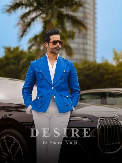 The complete look: a bold blue blazer, crisp white shirt, and light trousers. This is the epitome of sophisticated summer style, designed for the man who owns the moment.