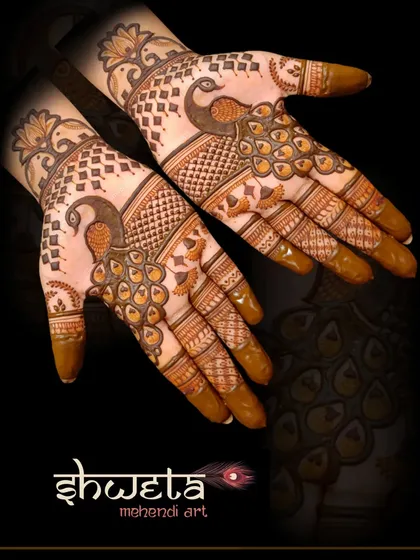 A stylish peacock design on the back of the hands. The cutwork technique creates a lovely contrast and gives the design a modern, edgy feel.