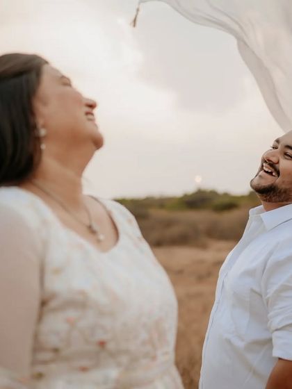 A moment of pure, uninhibited laughter, showing the fun and joy of the pre-wedding experience.