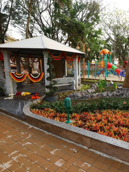 A classic white gazebo serves as the focal point in this community park. I surrounded it with colorful bromeliad beds and stone edging to create a welcoming public seating area.