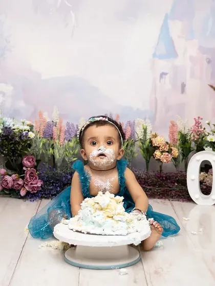 Covered in cake and happiness! This is what a successful cake smash looks like. We capture the messy, joyful aftermath in our beautiful fairytale castle setting.