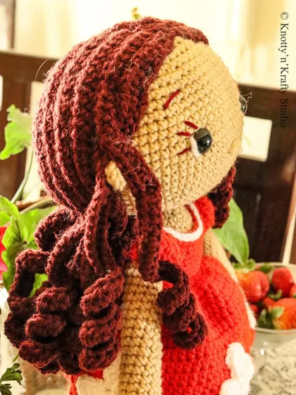 A side view of Lily, showing the detail in her bouncy, individually stitched brown curls. It took two full days to create her hair, and I think it gives her so much personality.