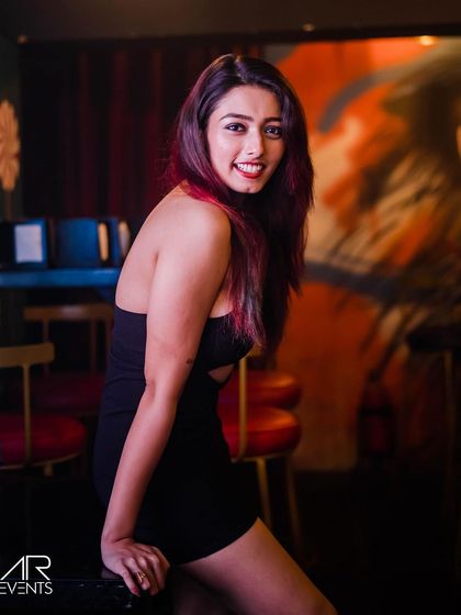 A guest with reddish hair, smiling for the camera.