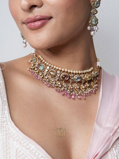 A Navratan choker in a soft pastel palette, featuring coral, sage green, and blush pinks for a fresh take on the traditional design.