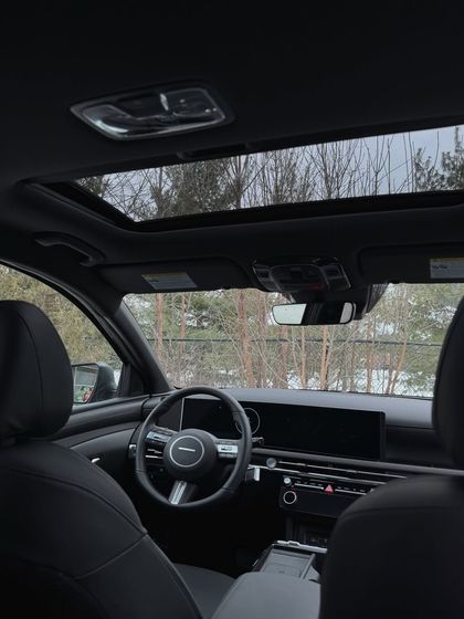 The interior of a car with a sunroof, an aesthetic shot that contributes to a "luxe life" photo dump.