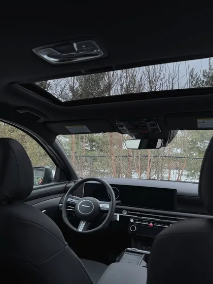The interior of a car with a sunroof, an aesthetic shot that contributes to a "luxe life" photo dump.
