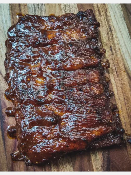 A full rack of my Barbeque Pork Ribs, ready to be devoured. The slow-grilling process ensures every bite is juicy and flavourful.