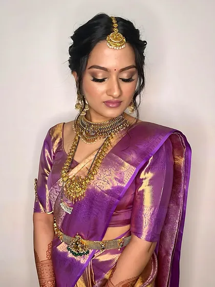 A vision in purple and gold, this South Indian bride's makeup features a soft shimmer on the eyelids and a defined brow to frame the face beautifully.