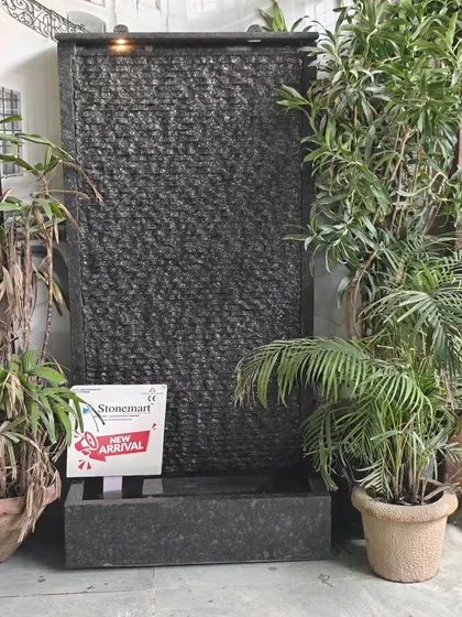 The granite waterfall shown in an indoor setting, demonstrating its versatility. It requires no special plumbing, just a power source.