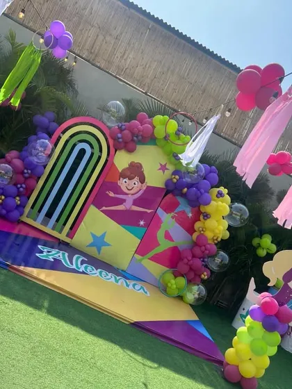 A vibrant and energetic gymnastics-themed party, with a colorful backdrop and props that celebrate movement and fun.