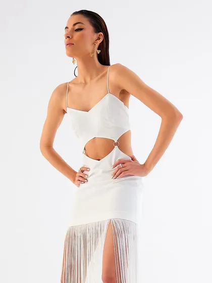 A powerful pose in the white fringe dress from Tisharth by Shivani, showcasing confidence and style.
