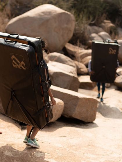 Our crew hauling crash pads to the climbing spot in Hampi. We bring all the necessary safety gear so you can focus on the climb.