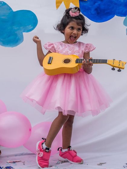 Rocking out in her pink party dress. The full tulle skirt is perfect for dancing, and the comfortable design lets her be the life of the party.