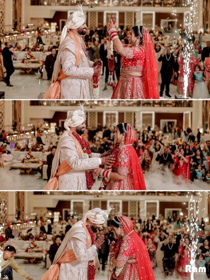 A collage of the Varmala ceremony, capturing the moment the bride places the garland on the groom, their shared smiles, and their final pose together, all amidst a shower of pyrotechnics and smoke.