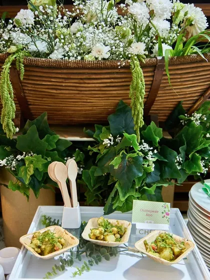 Our Chutneywale Aloo served in eco-friendly bowls against a backdrop of lush greenery. This setup highlights our commitment to both flavour and sustainable presentation.