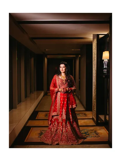 Another angle of Sanhita in the hotel corridor, capturing her elegance and the grandeur of her outfit.