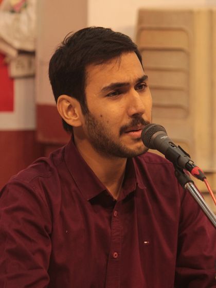 A student presenting his devotional song with focus and sincerity.