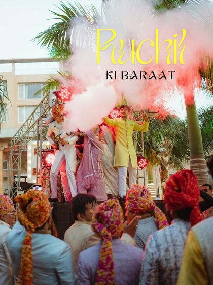 The groom's arrival on a custom-built stage, surrounded by friends and vibrant smoke effects, sets an energetic tone for the wedding festivities.