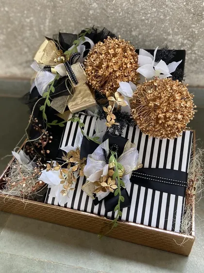 Modern and chic, this black and white striped hamper is accented with gold and white floral details. It’s a contemporary take on luxury gifting, ideal for corporate clients or anyone with a flair for bold design.